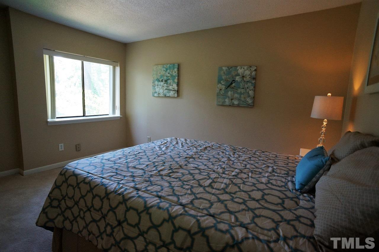 618 Pine Ridge Place, Unit 618 Raleigh, NC 27609 - Photo 12 of 20 a bedroom with a bed and a window