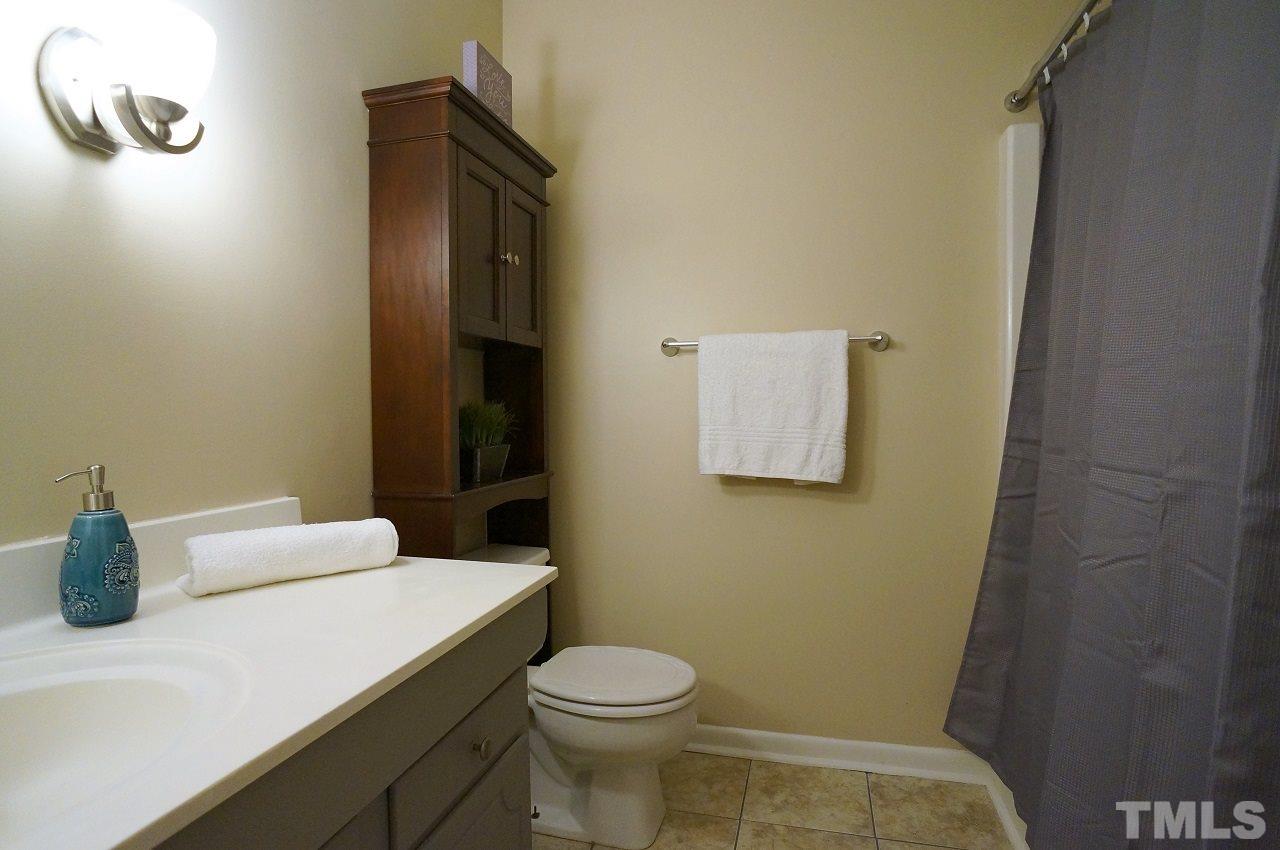 618 Pine Ridge Place, Unit 618 Raleigh, NC 27609 - Photo 17 of 20 a bathroom with a sink a toilet and mirror