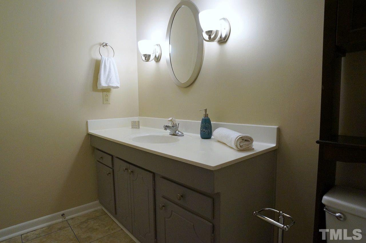 618 Pine Ridge Place, Unit 618 Raleigh, NC 27609 - Photo 18 of 20 a bathroom with a sink and a mirror