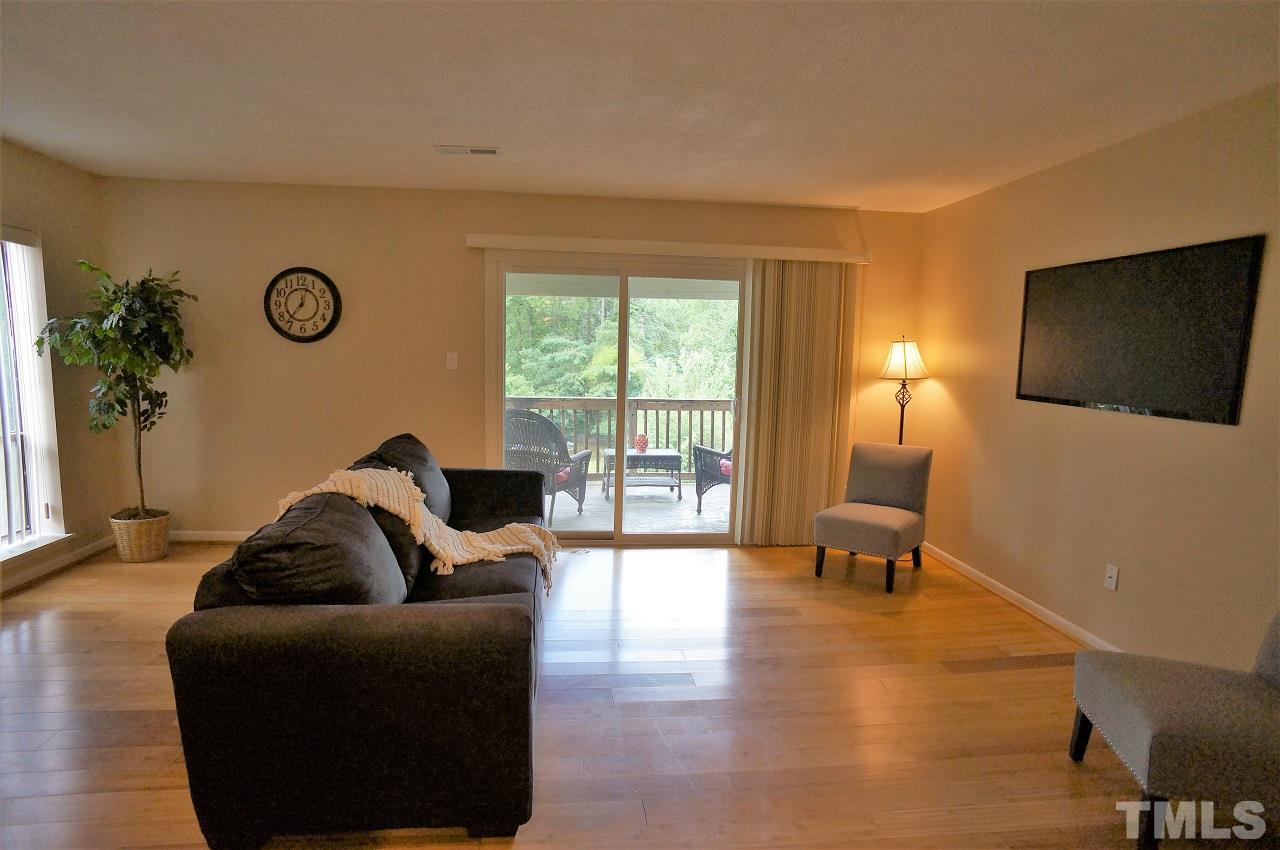 618 Pine Ridge Place, Unit 618 Raleigh, NC 27609 - Photo 6 of 20 a living room with furniture and a flat screen tv