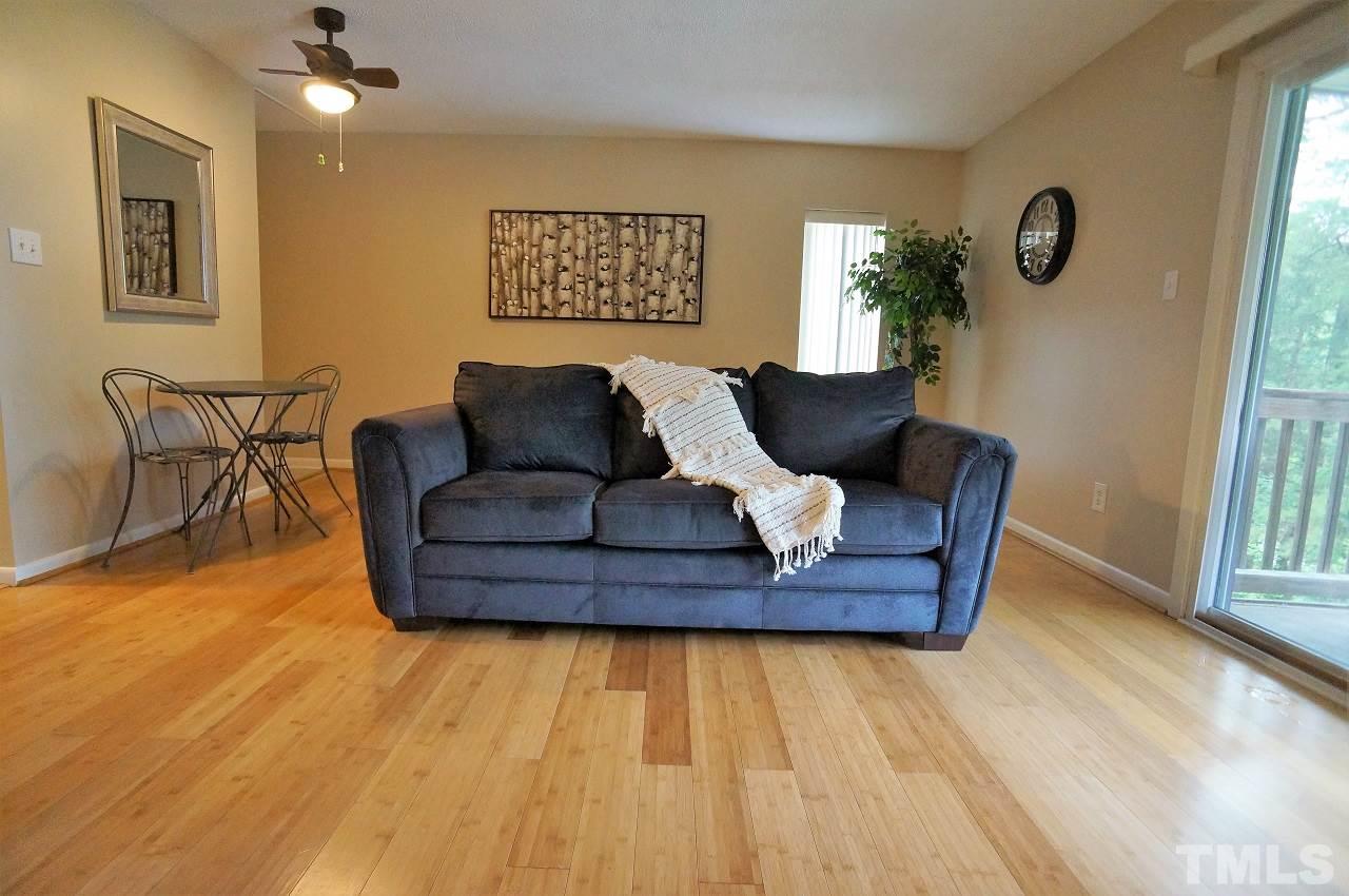 618 Pine Ridge Place, Unit 618 Raleigh, NC 27609 - Photo 7 of 20 a living room with furniture and a table