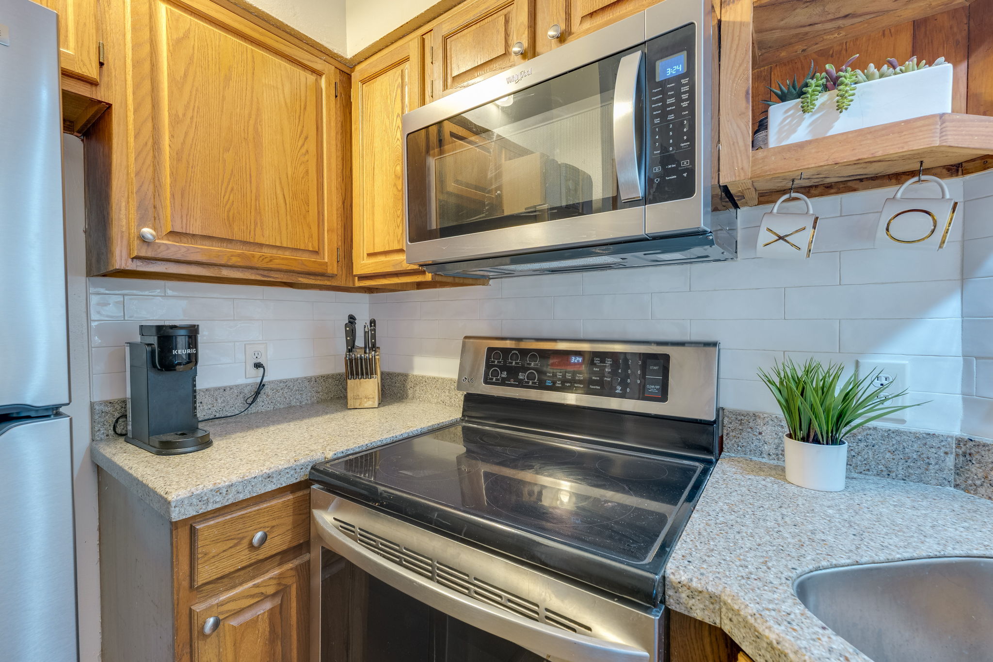 3809 Spicewood Springs Road, Unit 150 Austin, TX 78759 - Photo 21 of 35 a kitchen with granite countertop a sink and a stove