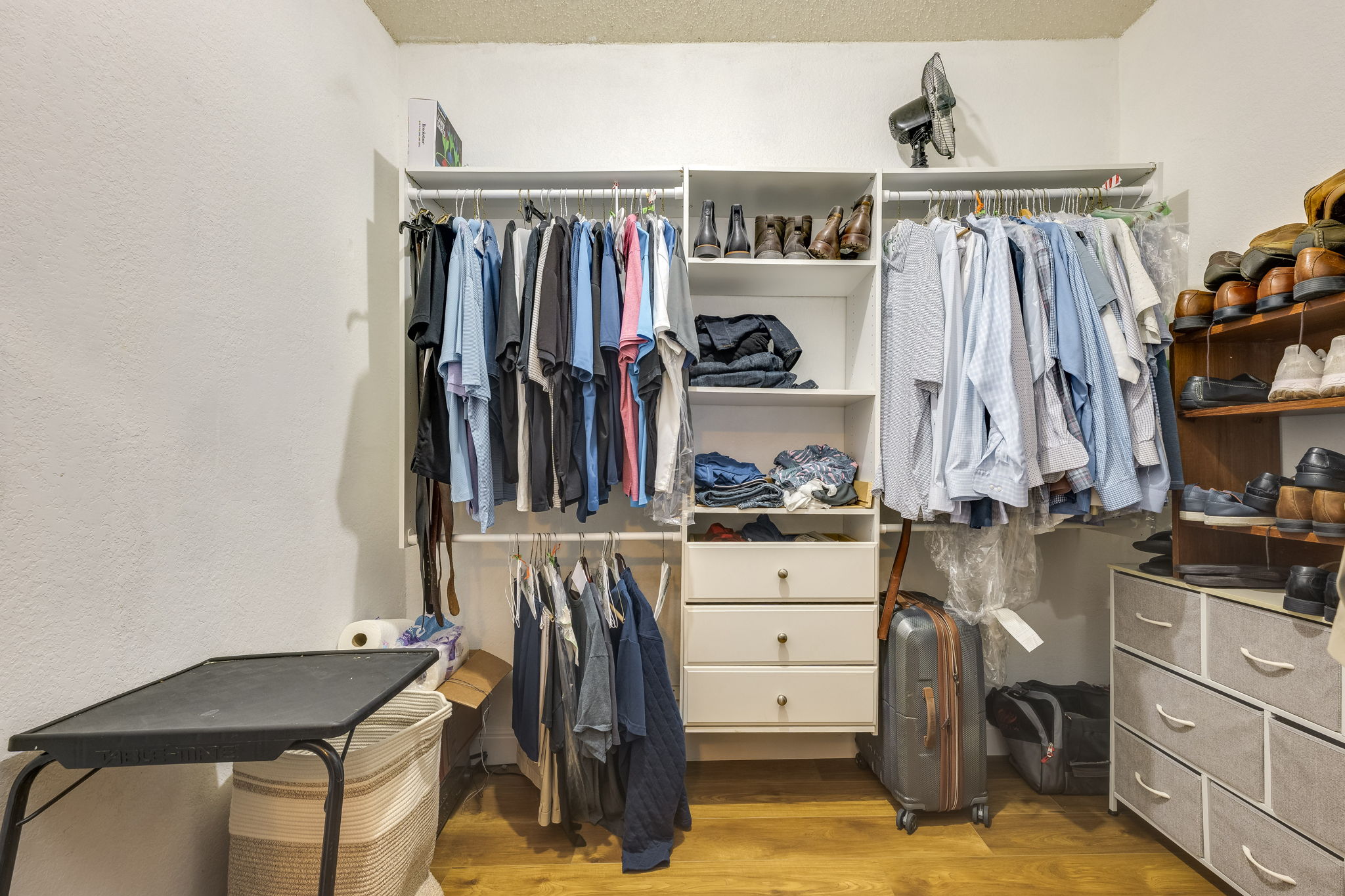 3809 Spicewood Springs Road, Unit 150 Austin, TX 78759 - Photo 27 of 35 a view of walk in closet with clothes and shoes