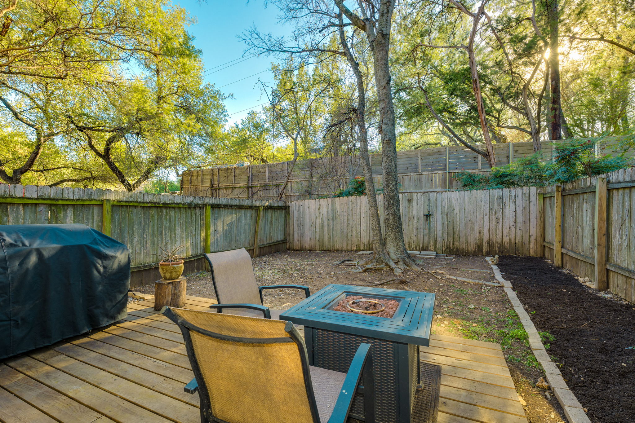 3809 Spicewood Springs Road, Unit 150 Austin, TX 78759 - Photo 31 of 35 a view of a patio with table and chairs with wooden floor and fence
