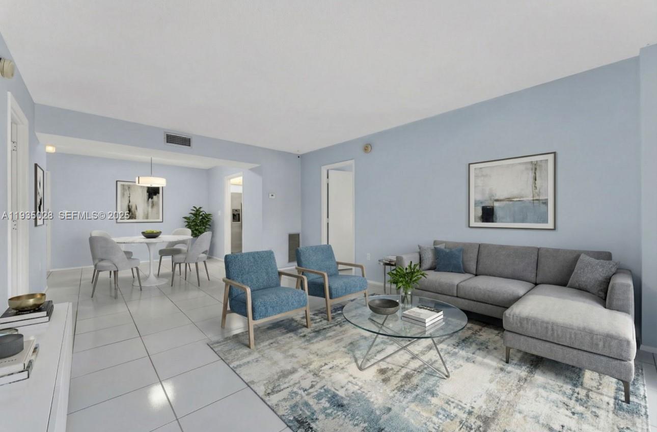 a living room with furniture a rug and a table