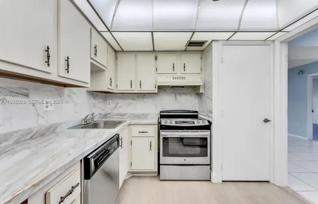 a kitchen with stainless steel appliances granite countertop a stove and a refrigerator