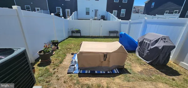 a room with a fireplace and potted plants