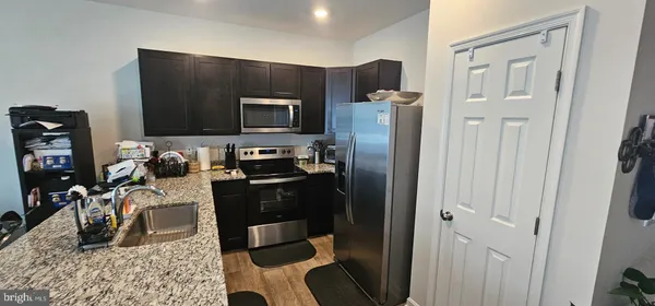 a kitchen with a refrigerator stove and a sink