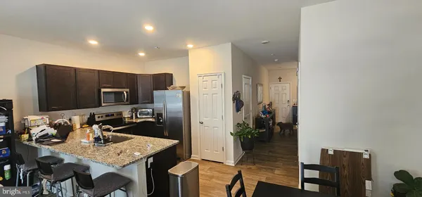 a kitchen with stainless steel appliances granite countertop a refrigerator and a stove