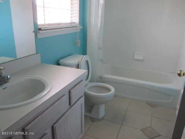 705 South Covered Bridge Road, Unit 2 St. Johns, FL 32259 - Photo 12 of 13 a bathroom with a sink a toilet and tub