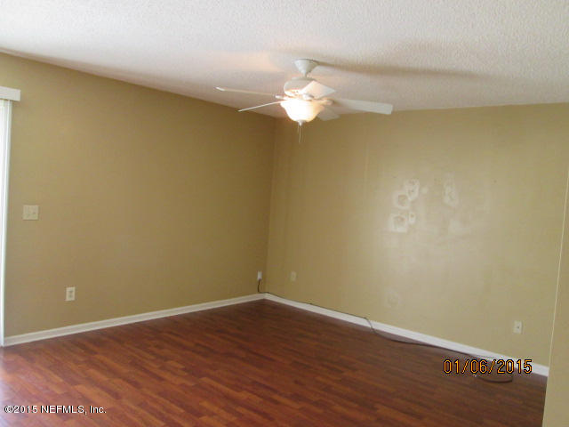 705 South Covered Bridge Road, Unit 2 St. Johns, FL 32259 - Photo 2 of 13 a view of a room with wooden floor and a ceiling fan