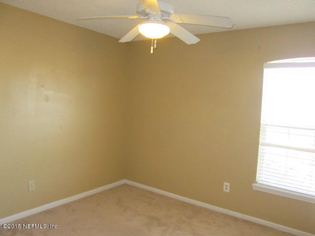 705 South Covered Bridge Road, Unit 2 St. Johns, FL 32259 - Photo 6 of 13 an empty room with a window and a ceiling fan