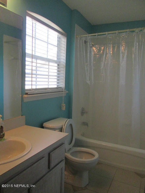 705 South Covered Bridge Road, Unit 2 St. Johns, FL 32259 - Photo 7 of 13 a bathroom with a sink a toilet and shower