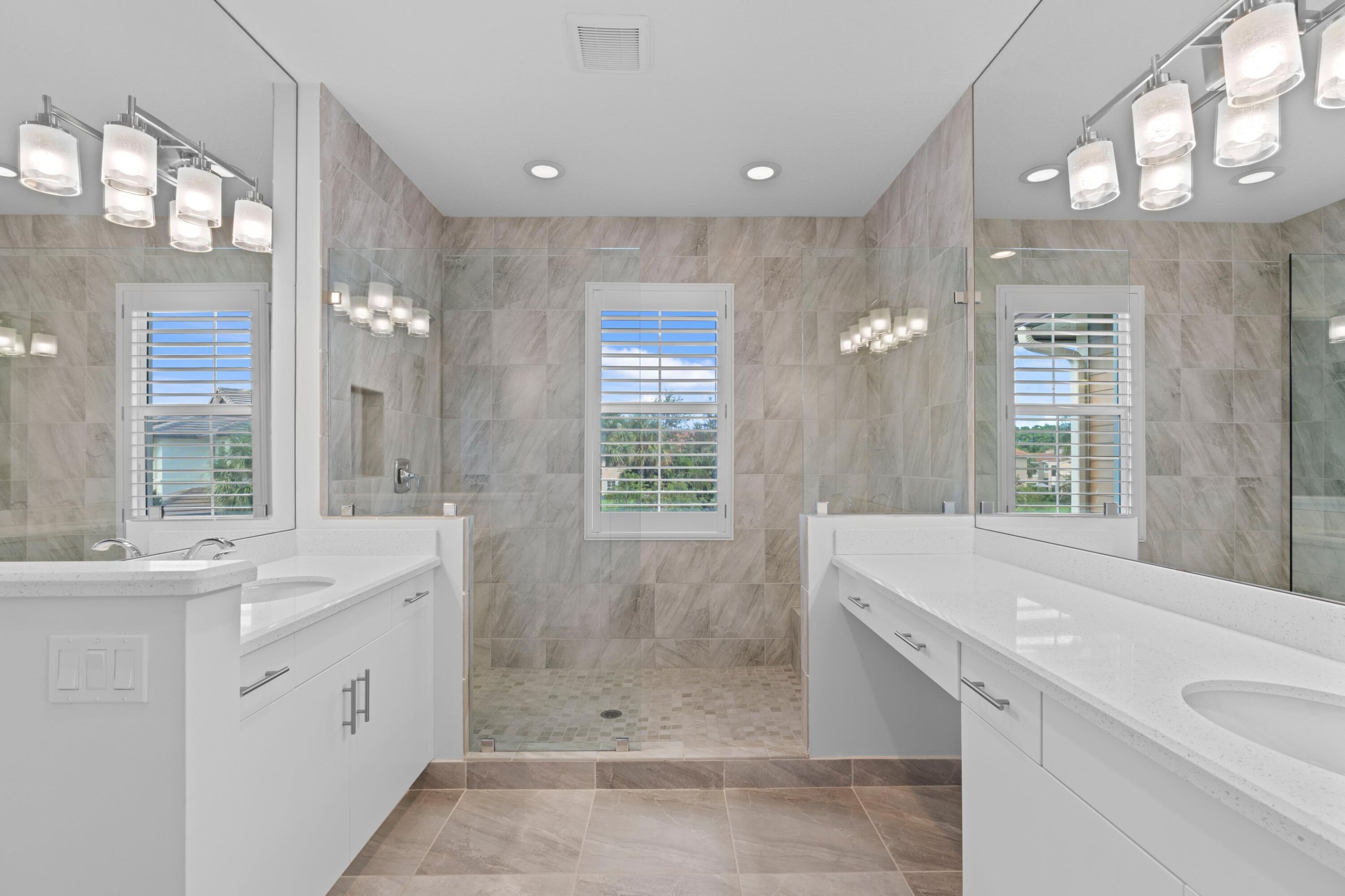 6693 Quiet Wave Trail, Unit 41 Boca Raton, FL 33433 - Photo 12 of 40 a spacious bathroom with a shower sink and mirror