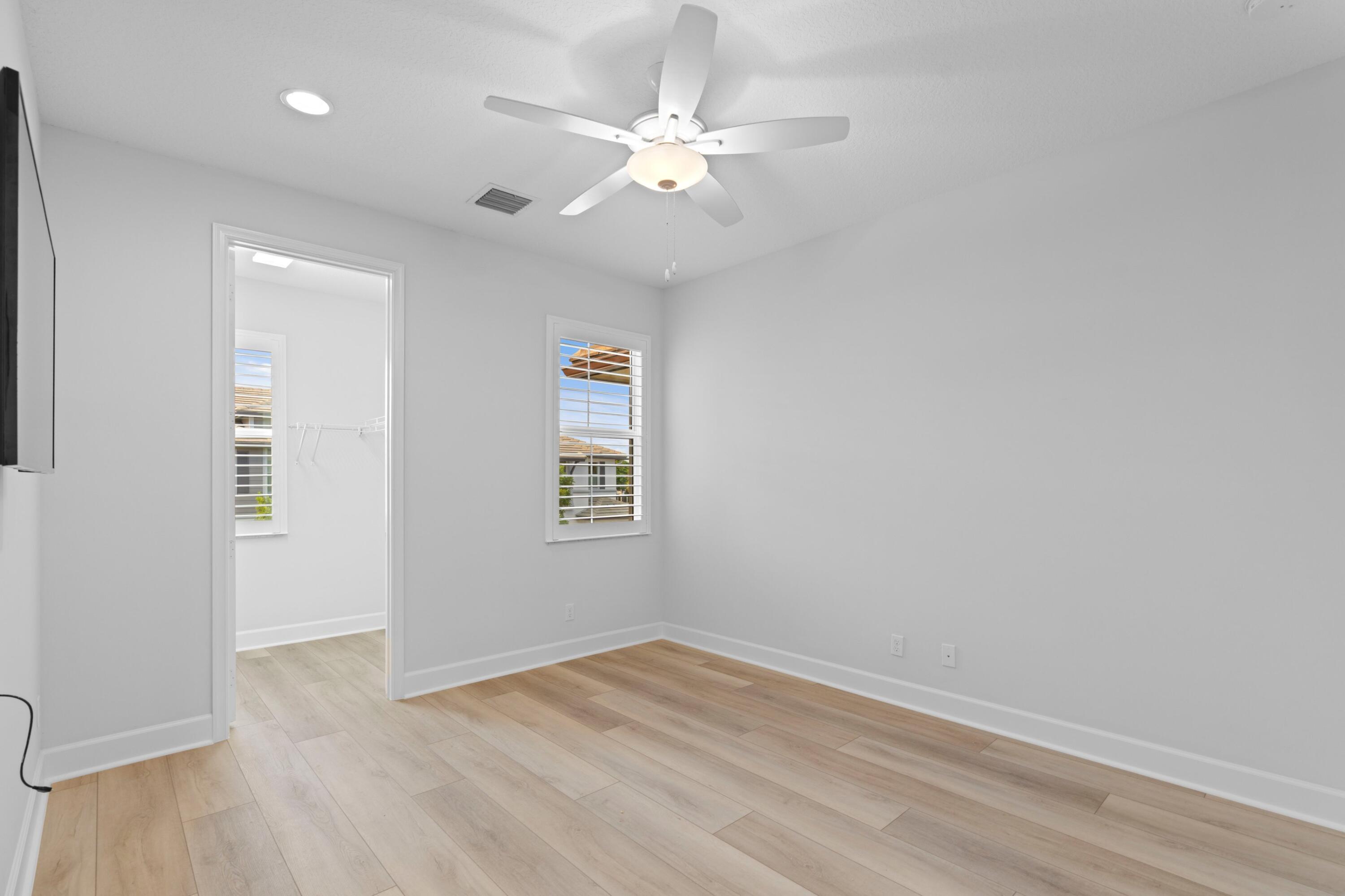 6693 Quiet Wave Trail, Unit 41 Boca Raton, FL 33433 - Photo 14 of 40 wooden floor in an empty room with a window