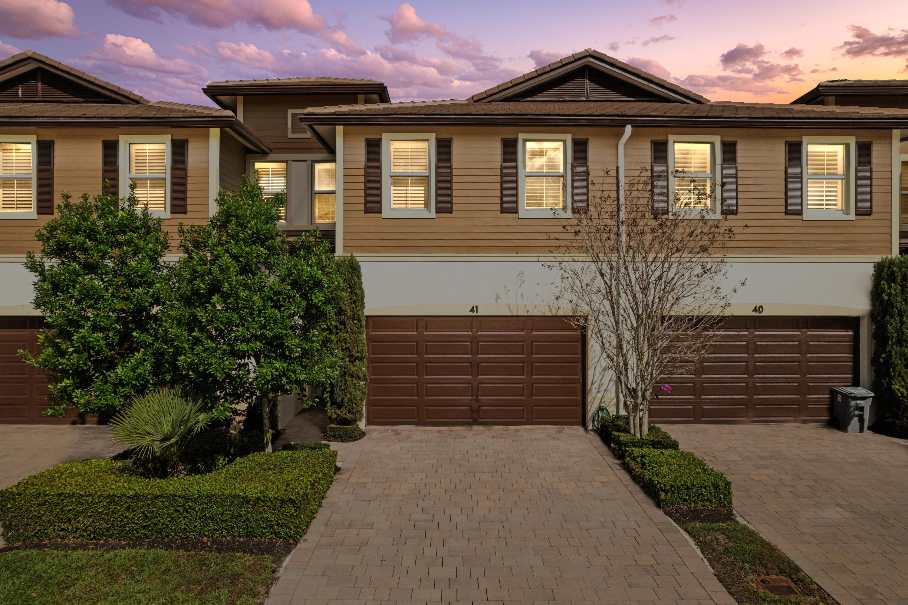 6693 Quiet Wave Trail, Unit 41 Boca Raton, FL 33433 - Photo 2 of 40 a front view of a house with a yard