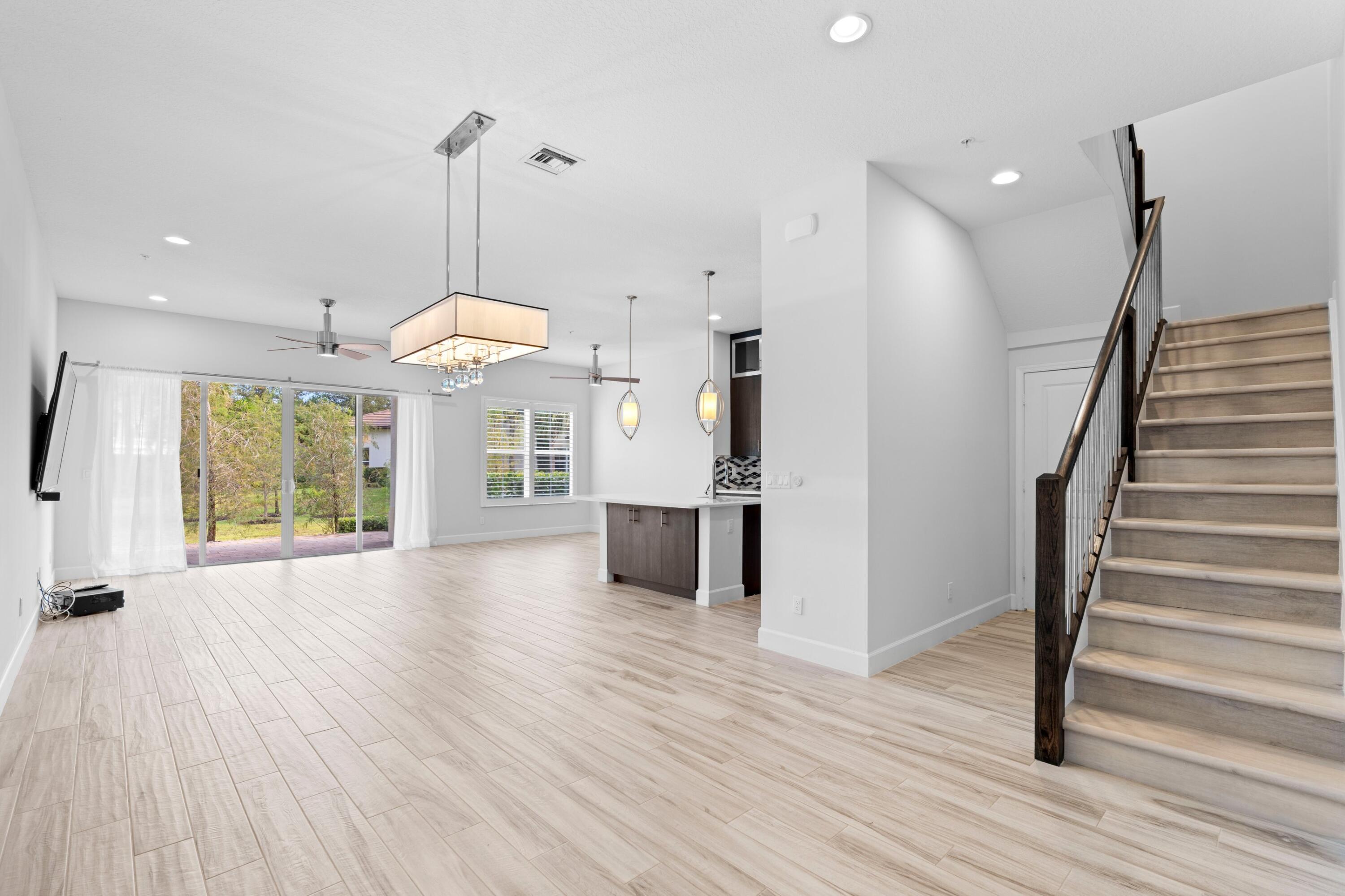 6693 Quiet Wave Trail, Unit 41 Boca Raton, FL 33433 - Photo 8 of 40 a view of a room with wooden floor kitchen view and a window