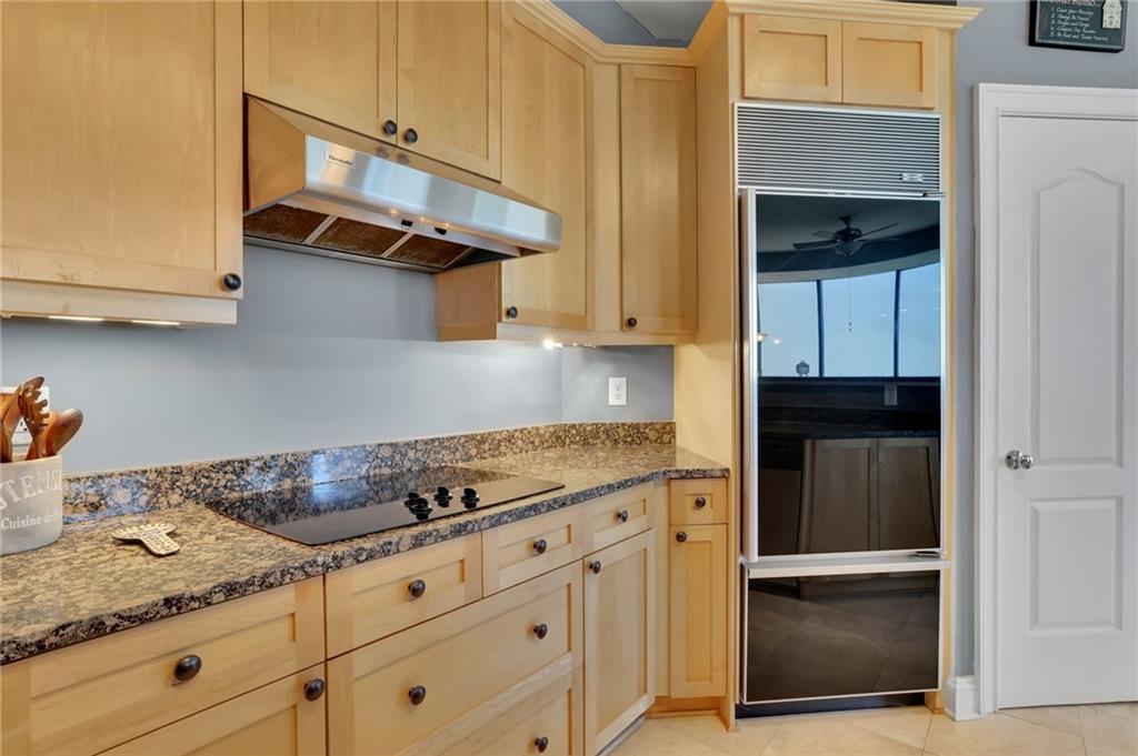 2828 Peachtree Road Northwest, Unit 1901 Atlanta, GA 30305 - Photo 13 of 35 a kitchen with granite countertop white cabinets and stainless steel appliances