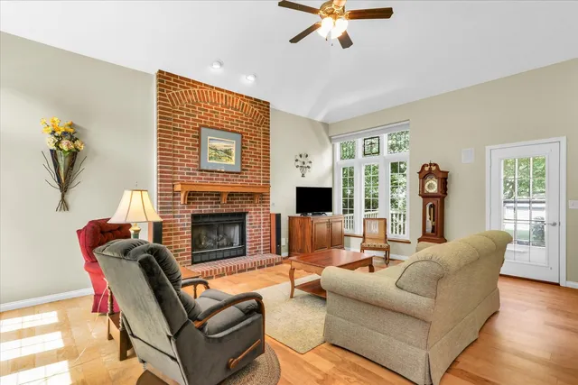 a living room with fireplace furniture and a flat screen tv