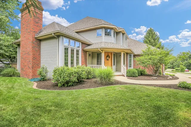 a view of a brick house with a yard