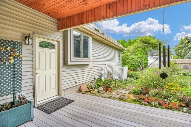 an aerial view of a house with swimming pool and large trees