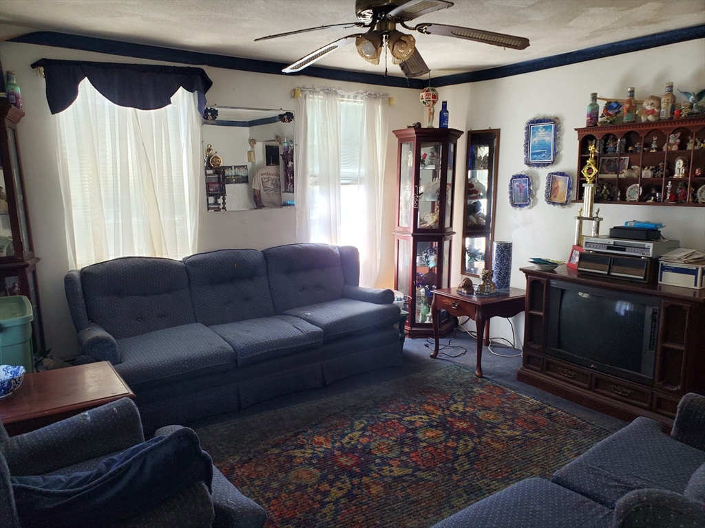 10-12 Carnes Street Lynn, MA 01905 - Photo 13 of 21 a living room with furniture a ceiling fan and a rug