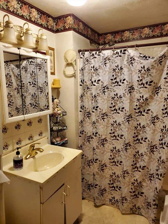 10-12 Carnes Street Lynn, MA 01905 - Photo 16 of 21 a bathroom with a sink and a mirror