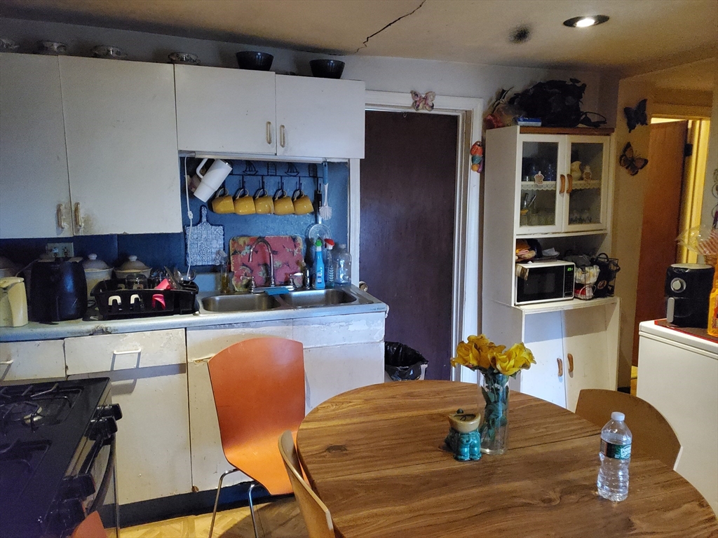 10-12 Carnes Street Lynn, MA 01905 - Photo 17 of 21 a kitchen with stainless steel appliances granite countertop a refrigerator and microwave