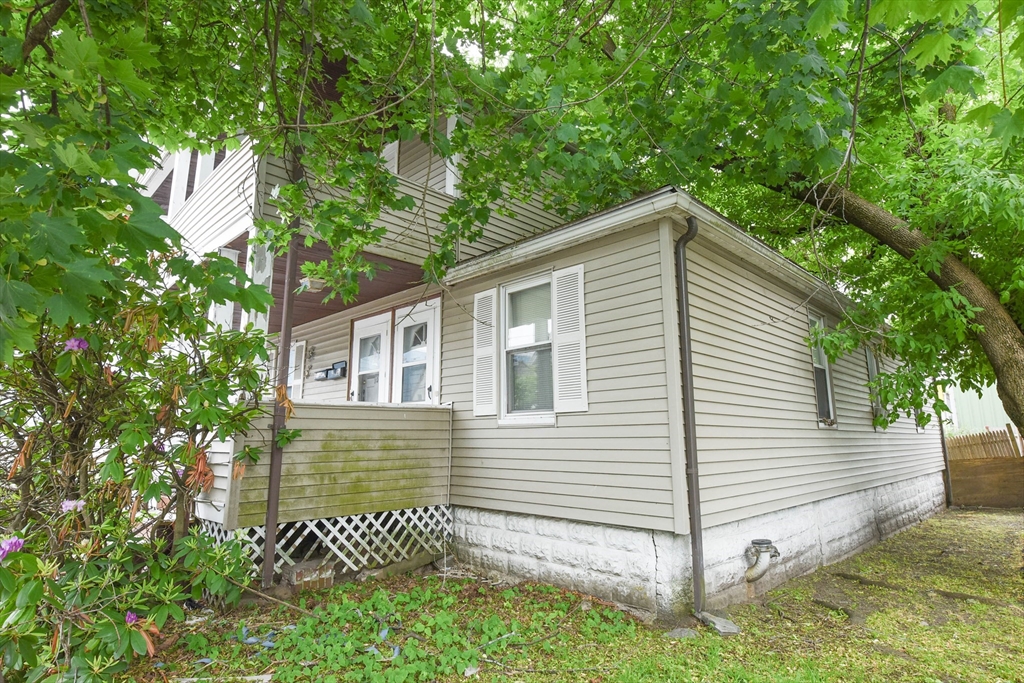 10-12 Carnes Street Lynn, MA 01905 - Photo 4 of 21 a front view of a house with a garden