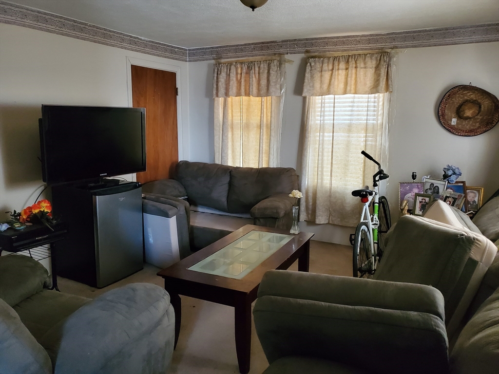 10-12 Carnes Street Lynn, MA 01905 - Photo 7 of 21 a living room with furniture and a flat screen tv