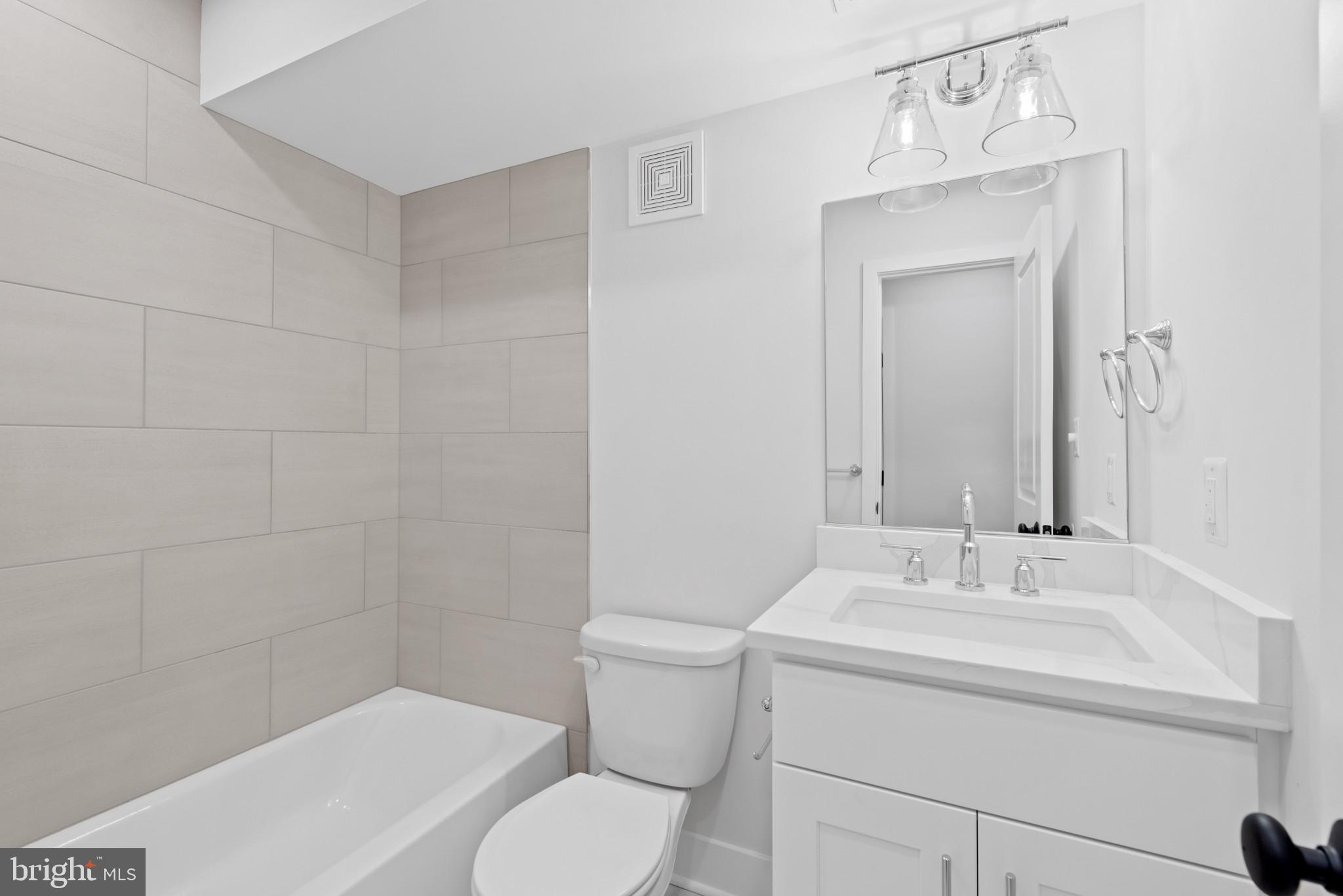 1434 Marshall Street Baltimore, MD 21230 - Photo 34 of 40 a bathroom with a sink a toilet and shower