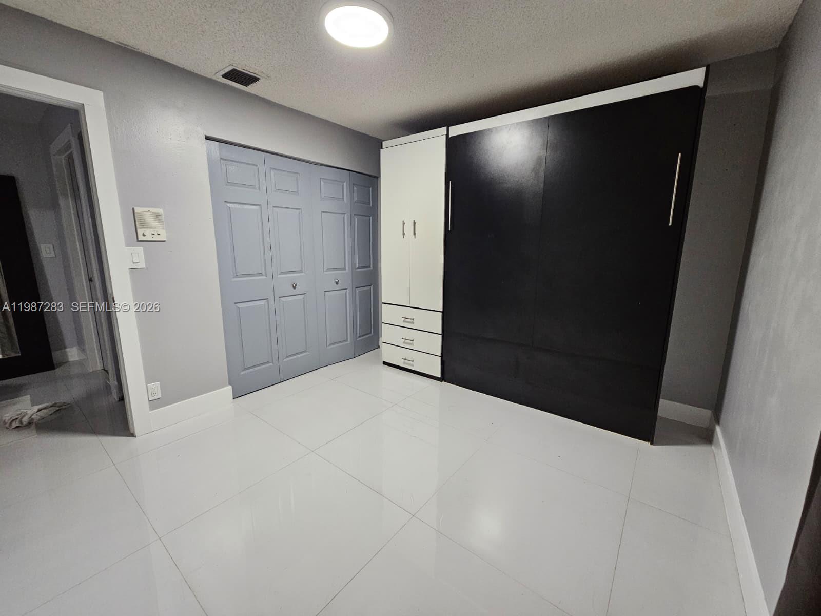 8003 Southwest 158th Place Miami, FL 33193 - Photo 12 of 20 a view of an empty room
