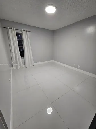 an empty room with staircase and white walls