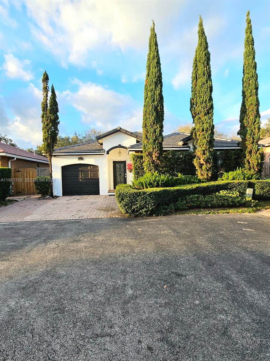 8003 Southwest 158th Place Miami, FL 33193 - Photo 2 of 20 a view of a garden with large buildings