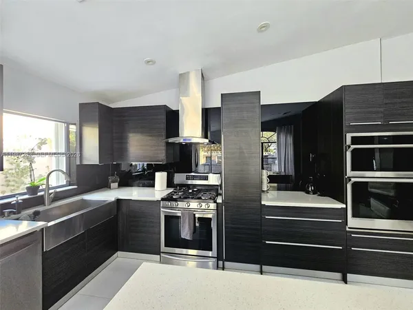 a kitchen with a sink appliances and cabinets