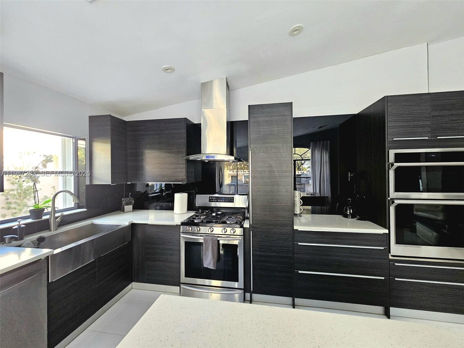 8003 Southwest 158th Place Miami, FL 33193 - Photo 4 of 20 a kitchen with a sink appliances and cabinets