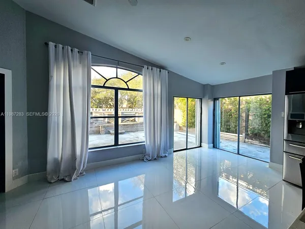 a living room with furniture and large windows