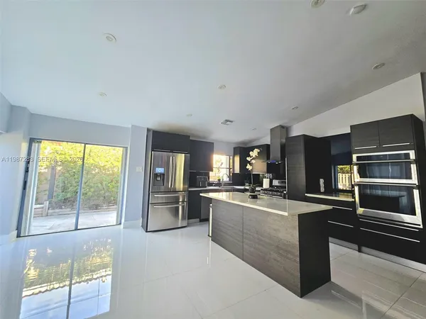 a kitchen with refrigerator and window