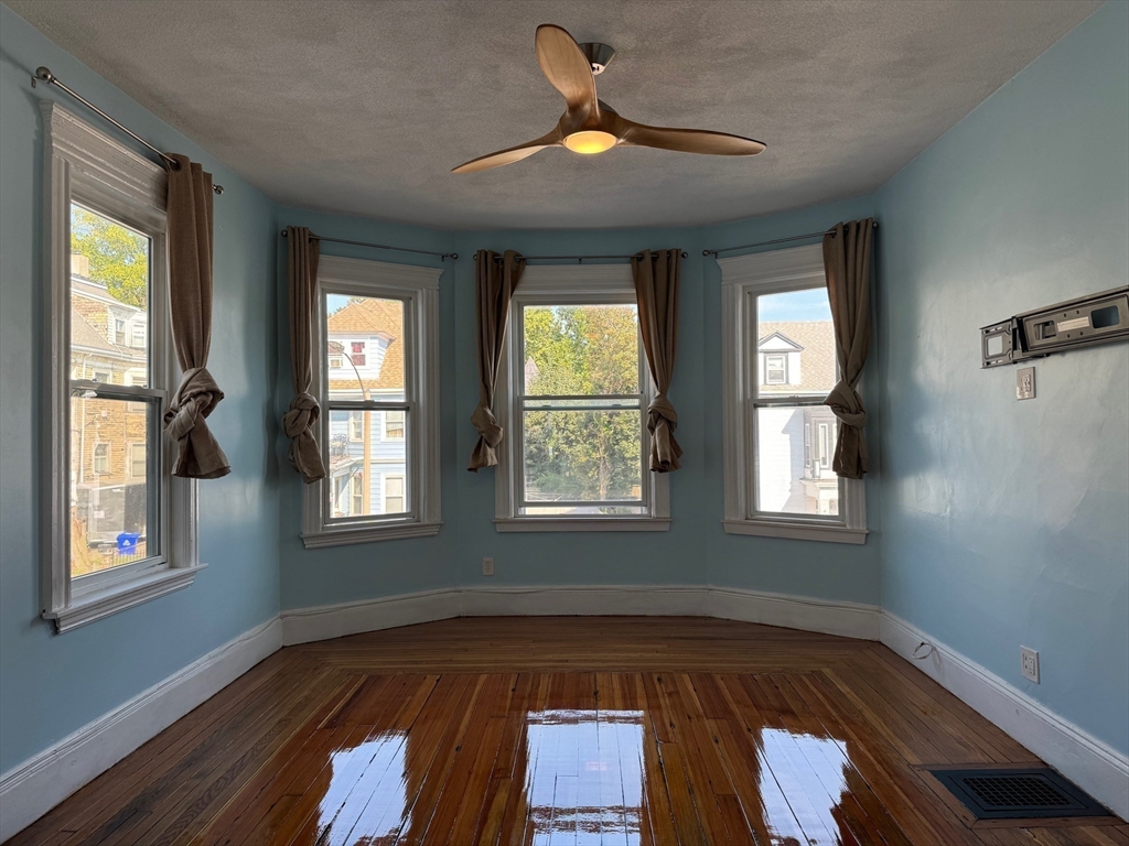 59 Centre Street, Unit PH Boston, MA 02124 - Photo 4 of 13 a view of room with window and hardwood floor