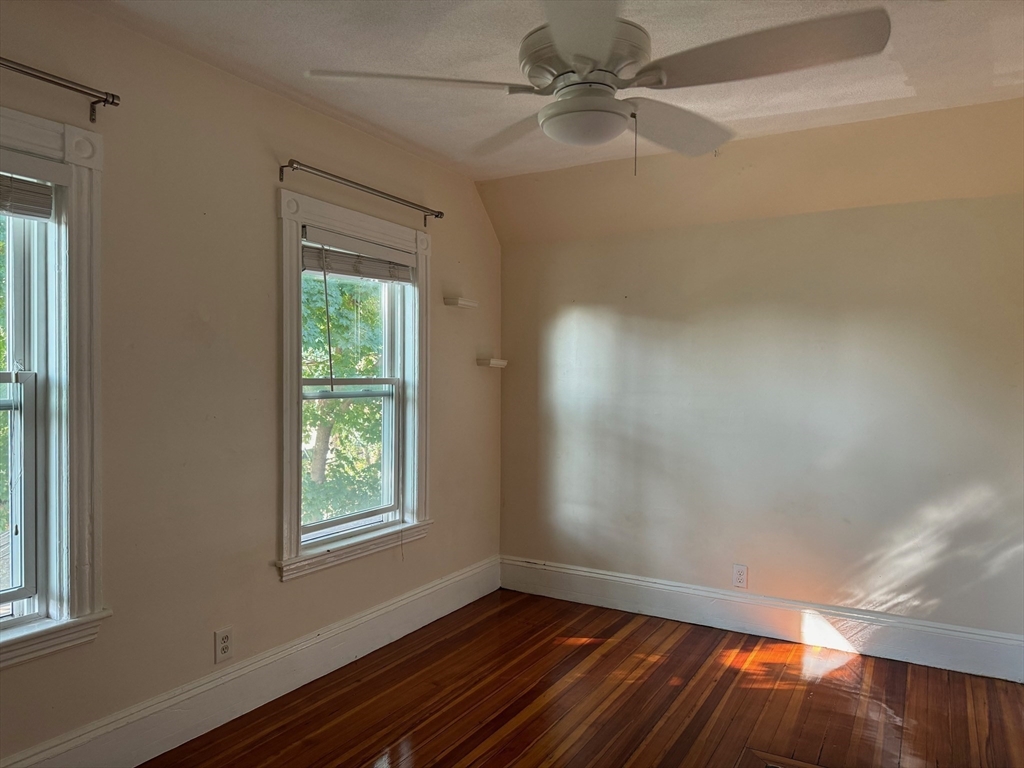 59 Centre Street, Unit PH Boston, MA 02124 - Photo 8 of 13 wooden floor in an empty room with a window