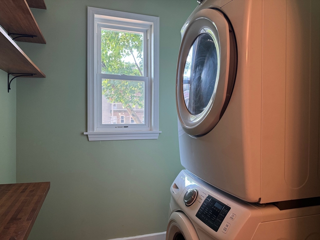59 Centre Street, Unit PH Boston, MA 02124 - Photo 10 of 13 a view of a room with washer and dryer