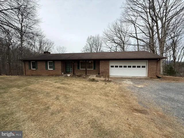 a view of a house with a yard and garage