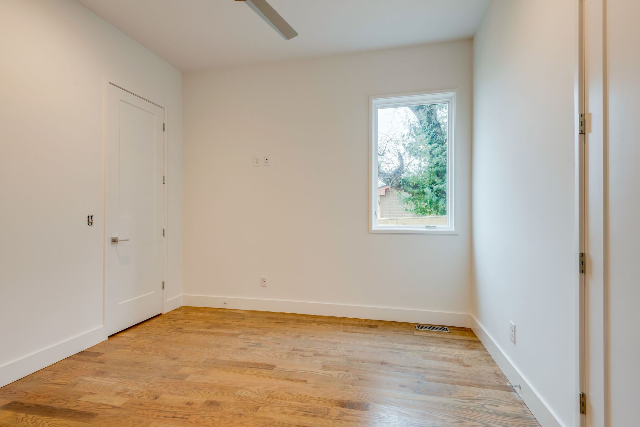 1022 B 9th Avenue South Nashville, TN 37203 - Photo 15 of 38 a view of an empty room with wooden floor and a window