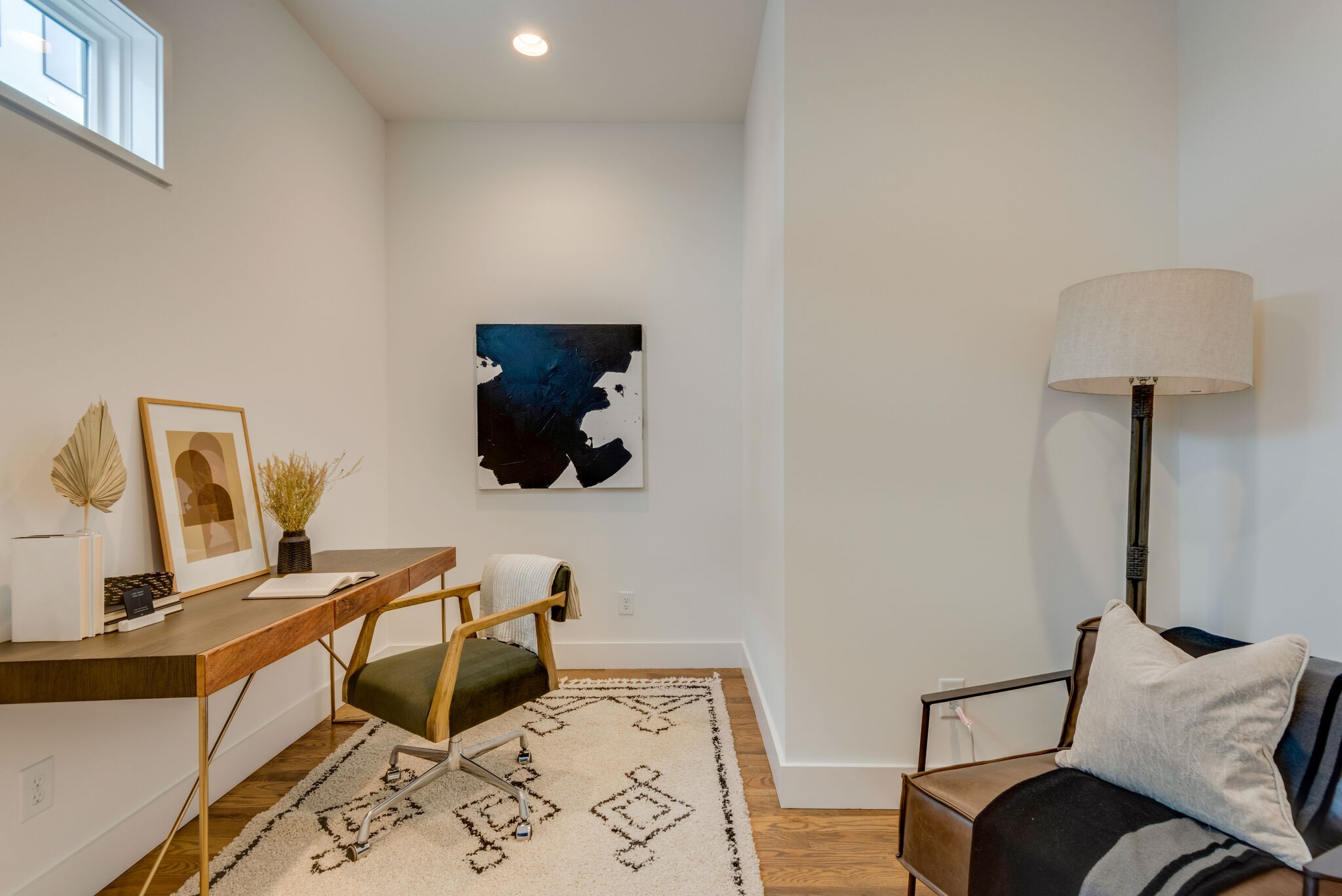 1022 B 9th Avenue South Nashville, TN 37203 - Photo 17 of 38 a living room with furniture and a lamp