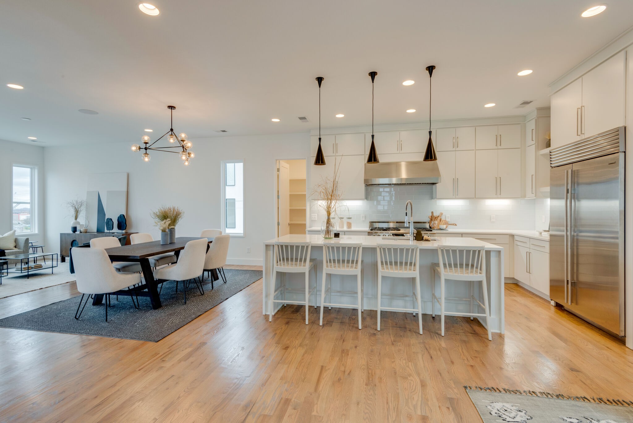 1022 B 9th Avenue South Nashville, TN 37203 - Photo 22 of 38 an open kitchen with kitchen island wooden floor center island and stainless steel appliances