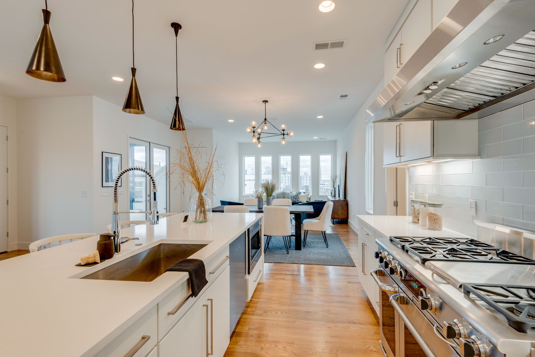 1022 B 9th Avenue South Nashville, TN 37203 - Photo 25 of 38 a large kitchen with kitchen island a stove a sink a center island and windows