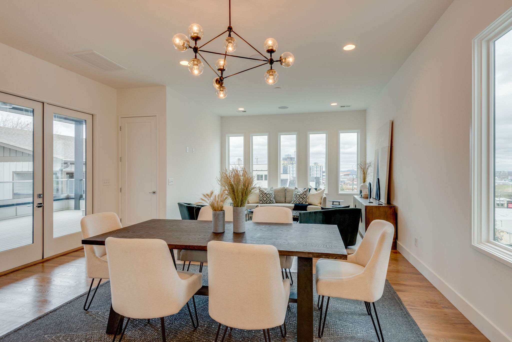 1022 B 9th Avenue South Nashville, TN 37203 - Photo 27 of 38 a dining room with furniture a chandelier and wooden floor