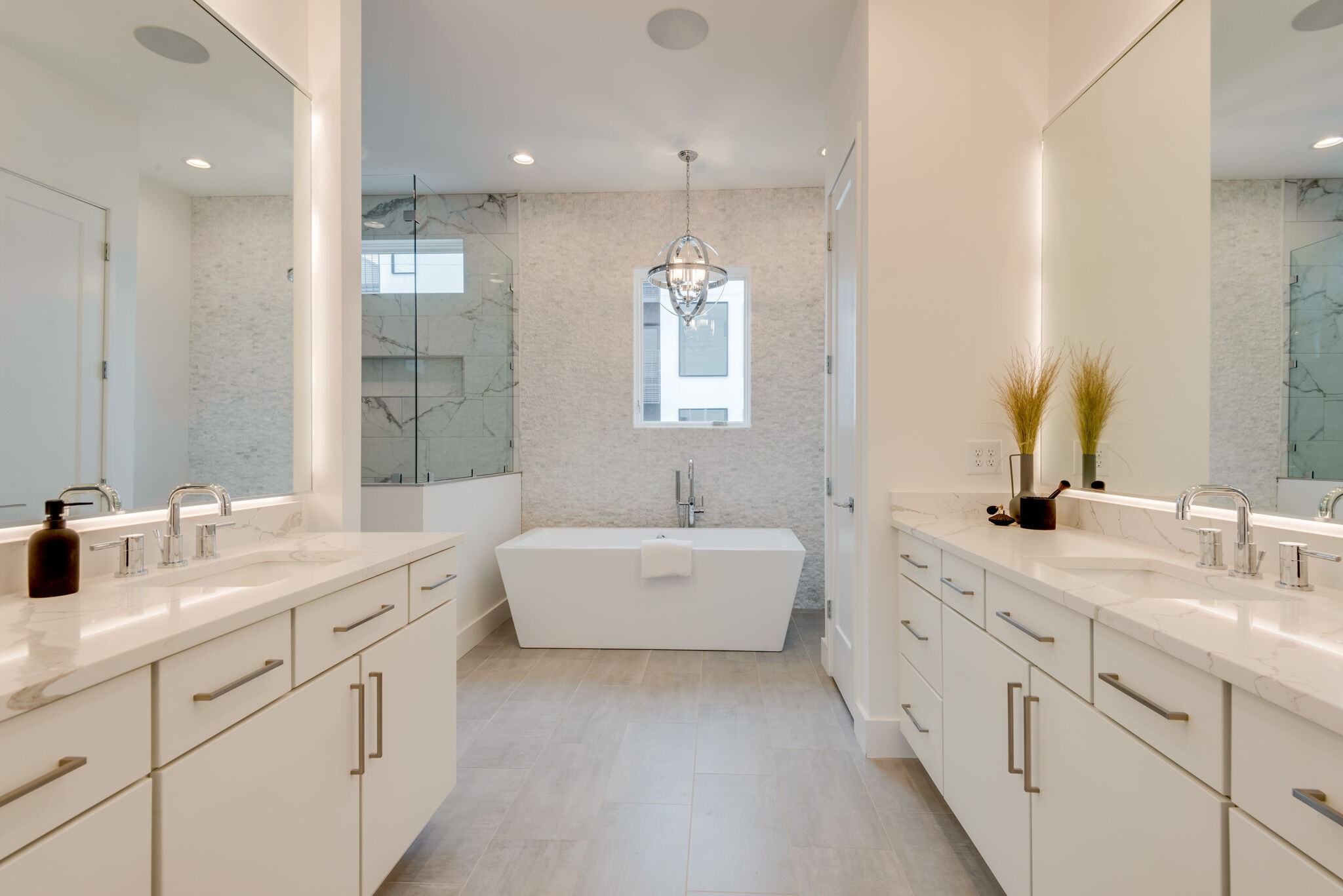 1022 B 9th Avenue South Nashville, TN 37203 - Photo 32 of 38 a bathroom with a double vanity sink a toilet a mirror and shower