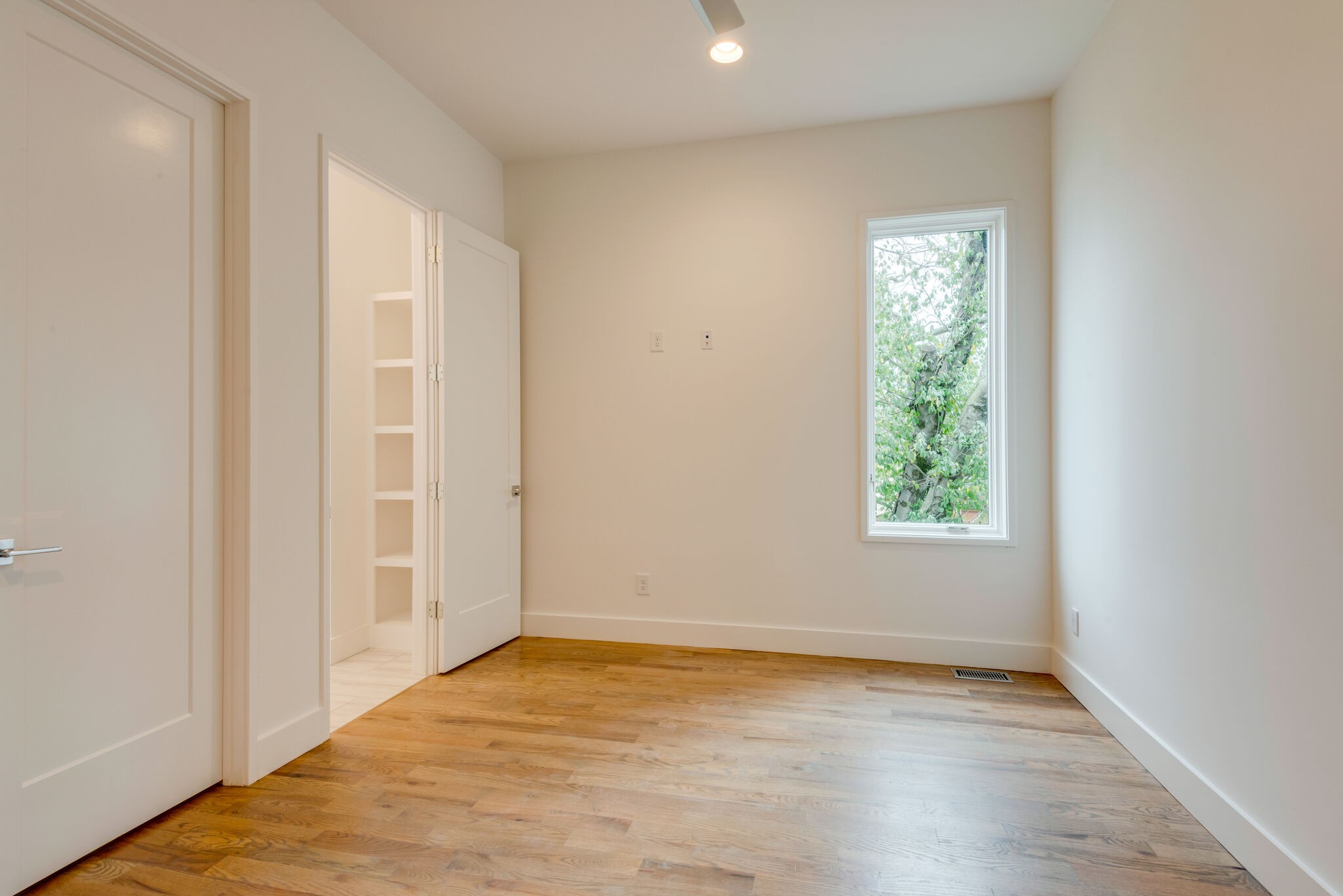 1022 B 9th Avenue South Nashville, TN 37203 - Photo 37 of 38 an empty room with wooden floor and windows