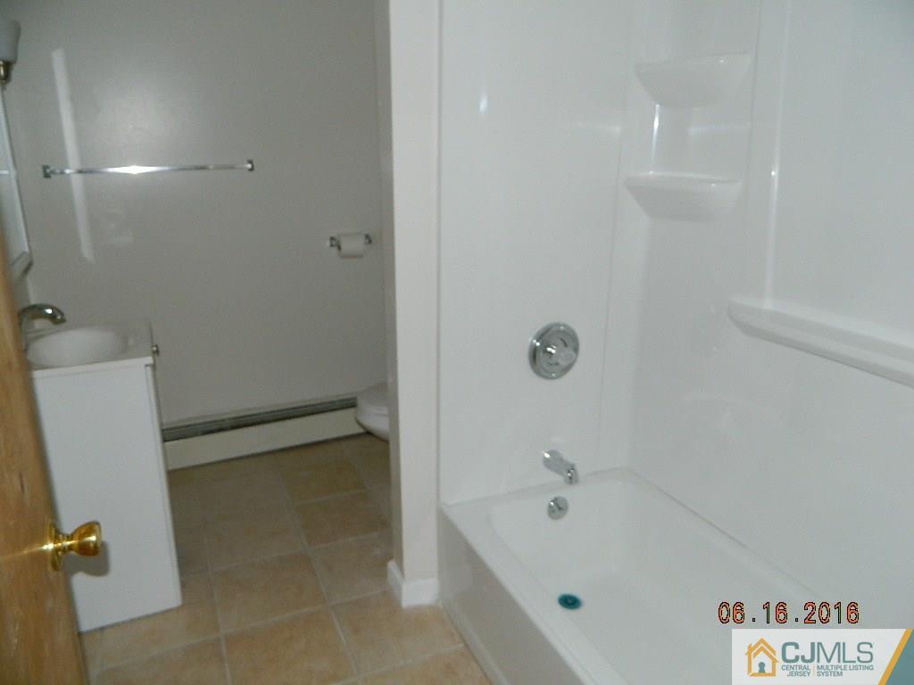 678 Ridge Road Monmouth Junction, NJ 08852 - Photo 8 of 9 a bathroom with a tub shower and vanity